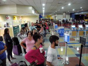 With only two flights remaining before the airport at Freeport, travelers and hopefuls pack the small airport.